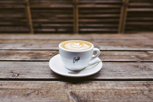 A cup of coffee on a wooden picnic bench