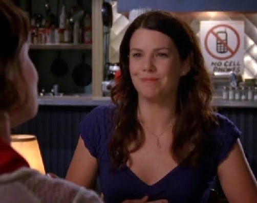 Lauren Graham as Lorelai Graham, wearing a Mona Lisa smile