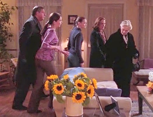 The Gilmore brood trails Trix around Lorelai's living room
