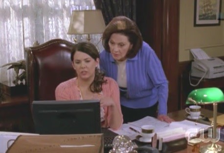 Emily peers over Lorelai's shoulder to learn spreadsheets