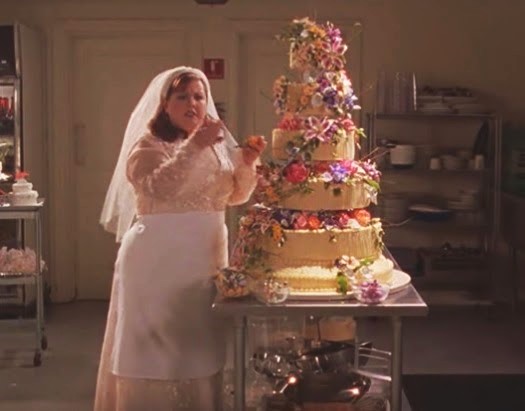 Sookie in her bridal gown tweaking her wedding cake the night before